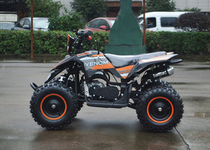 49cc Mini Quad ATV in orange/black combo parked sideways revealing left side of ATV when sitting on it
