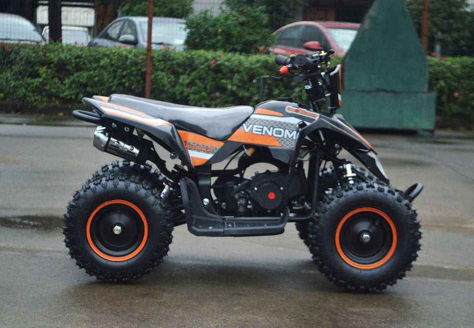49cc Mini Quad ATV in orange/black combo parked sideways revealing right side / metal pull start side of ATV