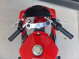 Sitting down view of 40cc Premium Gas Pocket Bike 4-Stroke in red/black combo facing forward revealing throttle and brake handles. Mostly red paint revealed, black windshield