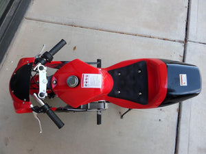Birds eye view of 40cc Premium Gas Pocket Bike 4-Stroke in red/black combo with handles sticking out. Main body in red paint and rear of bike in black paint.